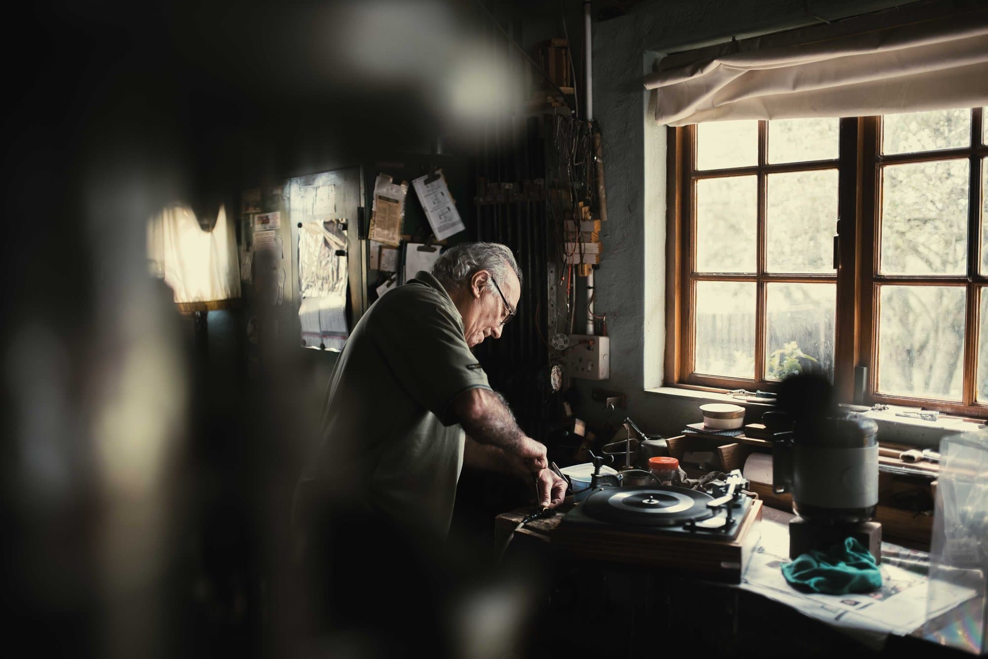 Older man working at the bench in his workshop